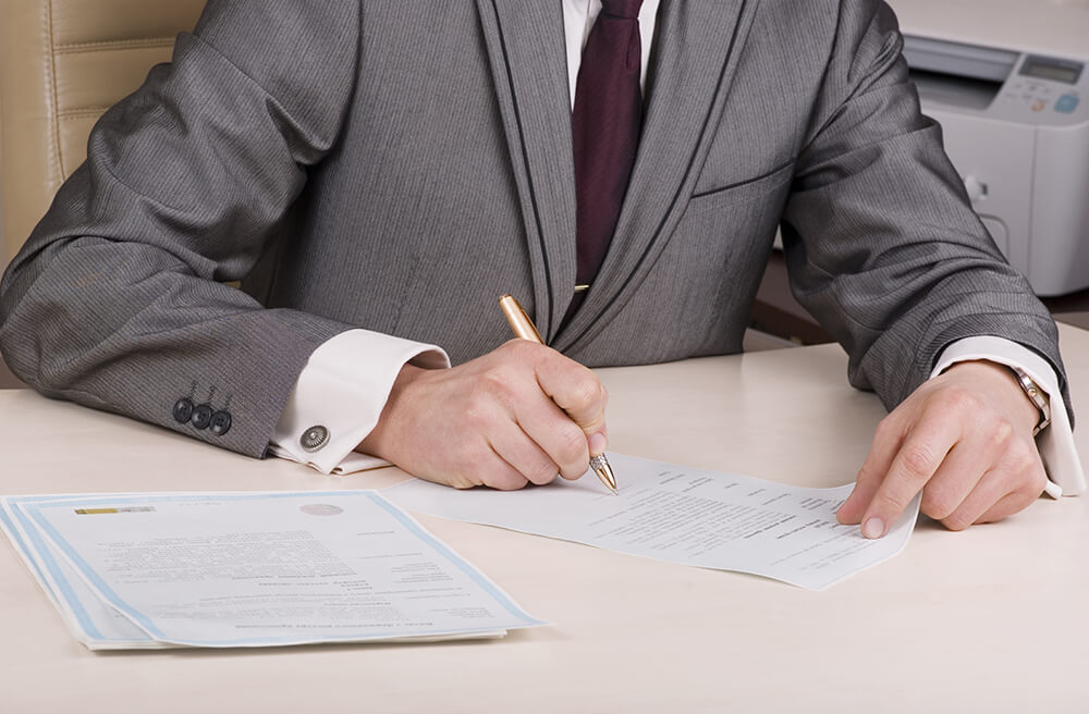 Image of Business man filling out paperwork
