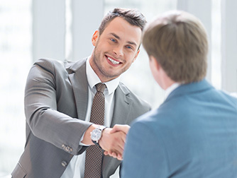 Young professionals shaking hands