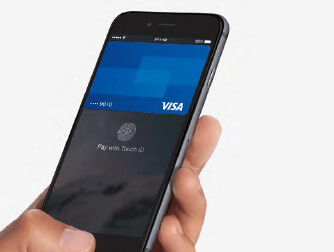 Someone holding up a smart phone that has an image of a visa credit card on the screen.